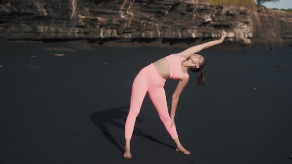 Front View of Young Woman Doing Morning Exercises at the Seashore