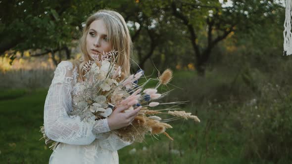 Wedding bouquet in the hands of a beautiful bride, the bride is holding a wedding bouquet of flowers