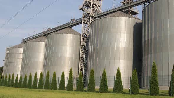 Silver Silos on Agro Manufacturing Plant for Processing Drying Cleaning Storage of Agricultural