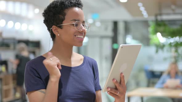 Portrait of Casual African Woman Doing Video Call on Tablet