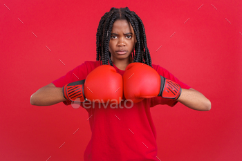 ng boxing gloves in studio with red background