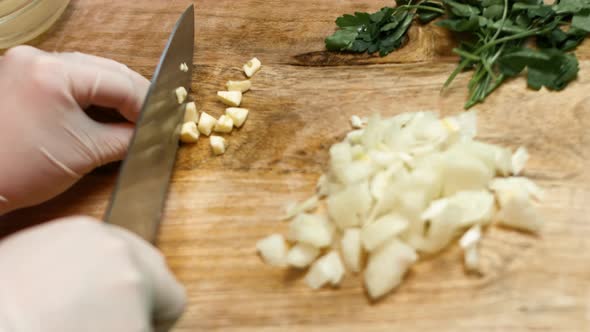 Clove of garlic cut in pieces on a wooden table.