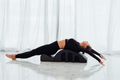 Woman with foam ark on floor for body tension and support during pilates class. - PhotoDune Item for Sale