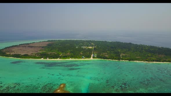 Aerial flying over landscape of perfect seashore beach voyage by shallow water and white sandy backg