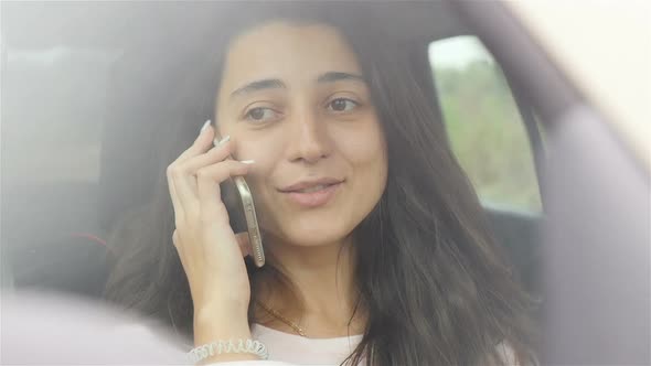 Closeup of a Girl Talking on the Phone in the Car