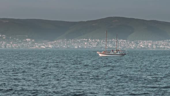 Sailboat in the Sea in the Evening Sunlight