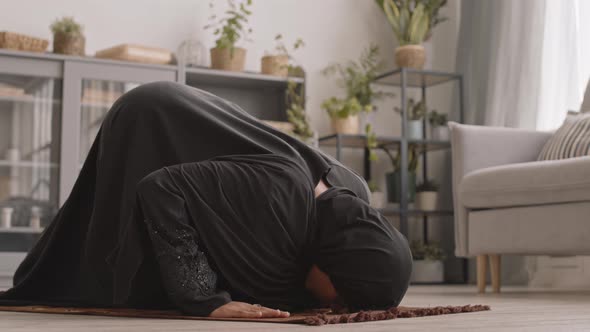 Young Muslim Woman Praying at Home