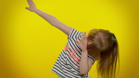 Cheerful Little Kid Child Girl Having Fun Dancing and Moving to Rhythm Dabbing Raising Hands