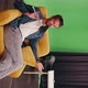 Caucasian Male Video Blogger Sits on a Yellow Chair in the Studio Talking - VideoHive Item for Sale