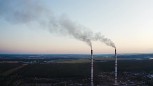 Two pipes with smoke on the beautiful landscape of nature