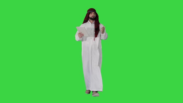 Sheikh Presenting Information or Product Using Digital Tablet on a Green Screen, Chroma Key.