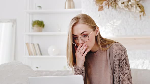 Portrait of Caucasian Woman Blonde Young Girl Student Wears Glasses Looks at Laptop Screen Browsing