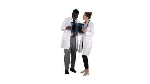 Young female doctor and afro american doctor looking at