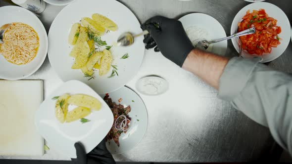 Fast Food Worker Serving Potatoes and Rice on the Plate