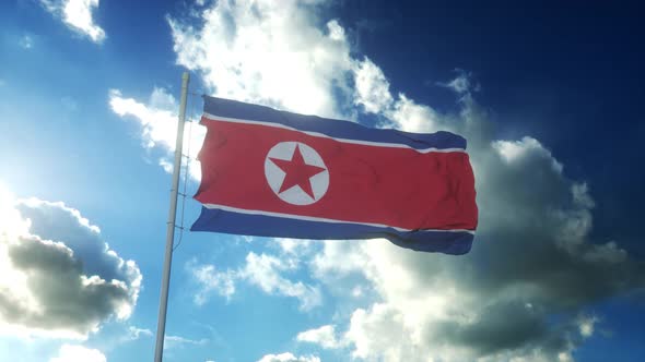 Flag of North Korea Waving at Wind Against Beautiful Blue Sky