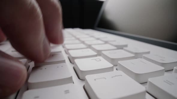 Close-up time lapse typing on keyboard with fingers. Macro soft focus dolly shot