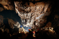 Spelunkers Admiring Underground Stalactites in a Cave - PhotoDune Item for Sale