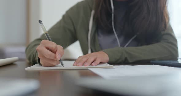 Woman write on the note do revision at home