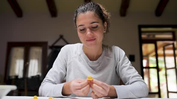 Cheerful woman cooking tortellini at home