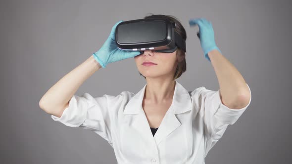 Feale Doctor Conducting Experimental Medical Procedure Wearing Virtual Reality Headset Isolated on