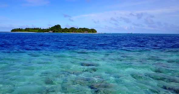 Luxury fly over copy space shot of a sunshine white sandy paradise beach and aqua blue water background