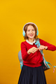 Happy schoolgirl with backpack, headphone having fun - PhotoDune Item for Sale