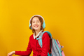 Happy schoolgirl with backpack, headphone having fun - PhotoDune Item for Sale