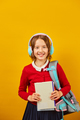 Schoolgirl with backpack, headphone and books in hand back to school - PhotoDune Item for Sale