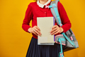Unrecognizable Schoolgirl with backpack, headphone and books in hand back to school - PhotoDune Item for Sale