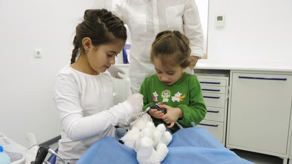 Little girls playing dentist