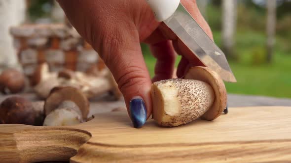 Mushroom Cut on a Wooden Board with a Knife