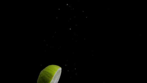 Lime Falling into Water Super Slowmotion, Black Background, lots of Air Bubbles, 4k240fps