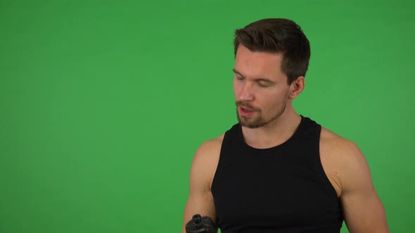 A Young Handsome Athlete Drinks From a Sport Bottle - Green Screen Studio