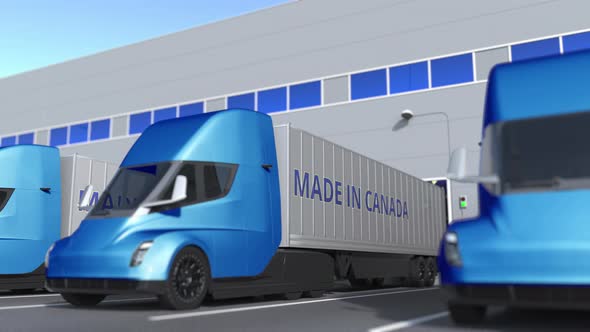 Modern Trailer Trucks with MADE IN CANADA Text at Warehouse