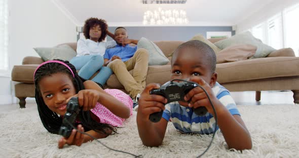 Children playing video game in living room