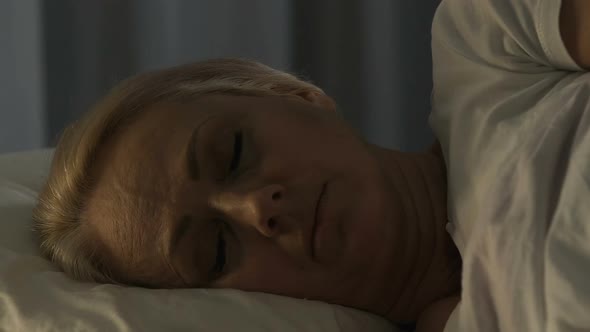 Worried Mature Female Sleeping in Her Bad, Suffering from Heartache, Close-Up