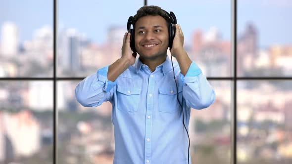 Happy Cheerful Guy Listening To Music in Headphones