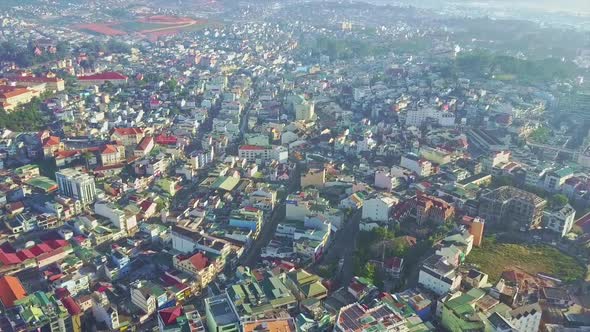 Drone Camera Shows Beautiful City Located on Green Hills