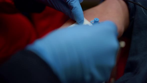 Paramedic Inserting Needle Cannula in Arm