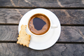 Top view on small cap of strong coffee espresso with cookie on wooden table. - PhotoDune Item for Sale