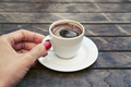 Beautiful female hand with a manicure holding a cup of strong espresso coffee. - PhotoDune Item for Sale