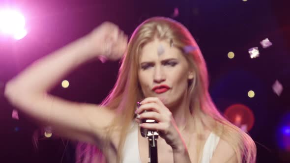 Girl Singing Dancing with Retro Microphone. Dynamic Change of Focus