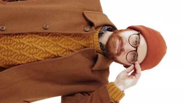 Charming Millennial Man Adjusts His Glasses and Takes Off Them Later Vertical Video White Background