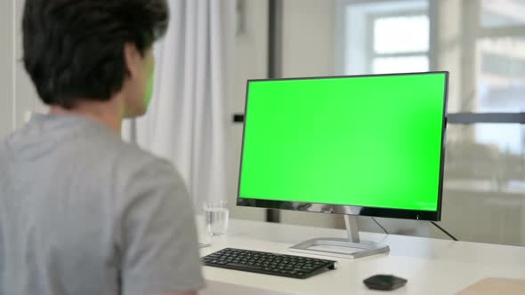 Video Call By Businessman on Desktop with Green Chroma Key Screen