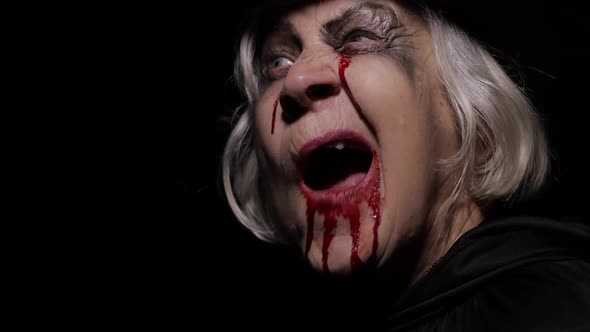 Old Witch Halloween Makeup. Elderly Woman Portrait with Blood on Her Face