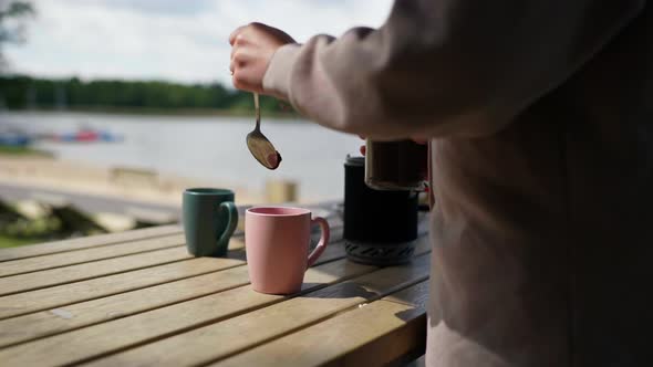 Girl Preparing Coffee in Nature