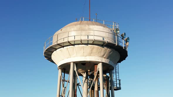 Water tower - elevated liquid storage tank. Metal reservoir for compressed gases hazardous chemicals