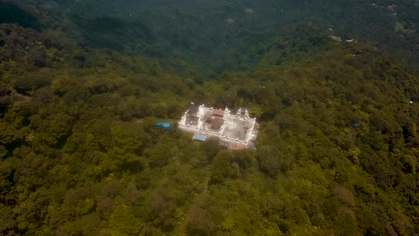 Aerial overhead shot flying away from the Pura Penataran Agung Lempuyang temple on Mount Lempuyang i