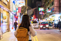 Young woman traveler walking in the Mong Kok night market in Hong Kong - PhotoDune Item for Sale