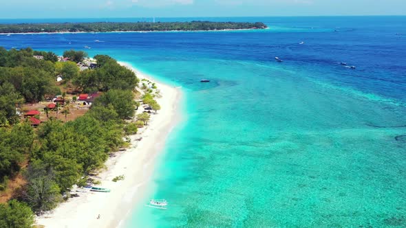 Aerial flying over tourism of marine shore beach lifestyle by blue green water and white sand backgr